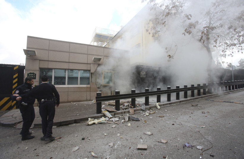 Turkish police officers react after an explosion at the entrance of the U.S. Embassy in Ankara February 1, 2013 (photo credit: REUTERS)