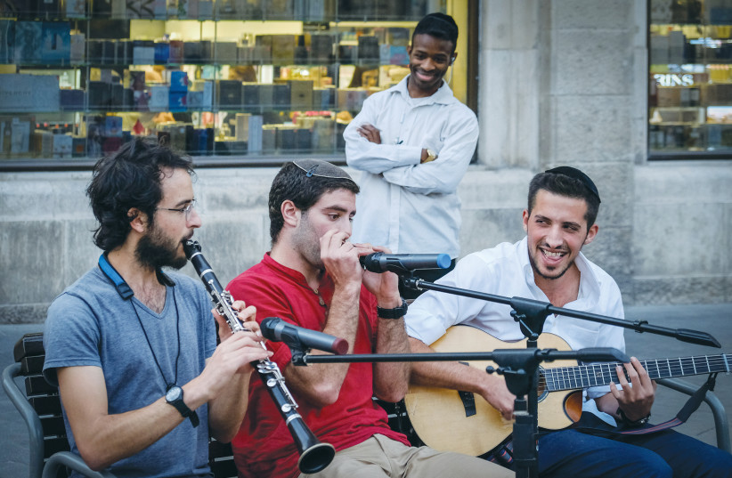 YOUNG MEN perform on a street in the center of Jerusalem.  (photo credit: SARA KLATT/FLASH90)