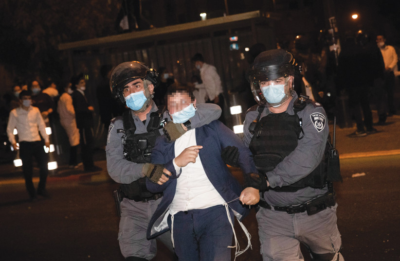 POLICE ARREST a protester during a demonstration against the enforcement of coronavirus emergency regulations, in Jerusalem’s Mea She’arim, earlier this month. (photo credit: YONATAN SINDEL/FLASH90)