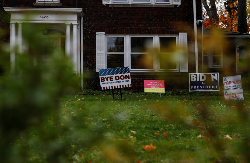 Campaign signs supporting U.S. Democratic presidential candidate Joe Biden are displayed on a lawn in Cleveland, Ohio, US, October 25, 2020. (photo credit: SHANNON STAPLETON / REUTERS)