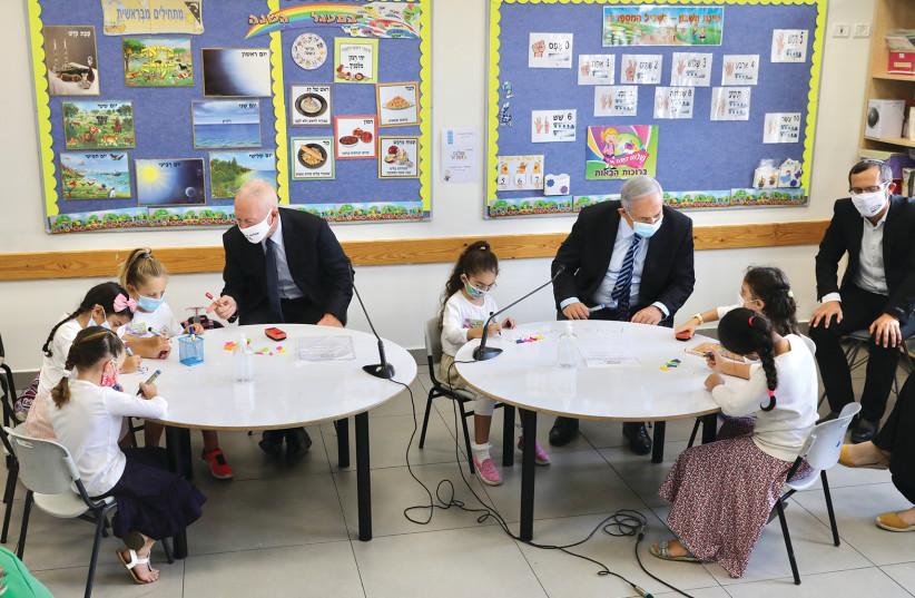 Prime Minister Benjamin Netanyahu and Education Minister Yoav Gallant visit a class at the opening of the 2020-2021 school year at the Netaim primary school in Mevo Horon on September 1 (photo credit: MARC ISRAEL SELLEM)
