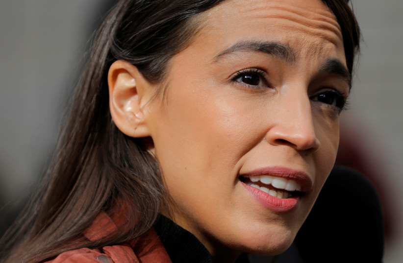 Congresswoman Alexandria Ocasio-Cortez addresses media as she arrives to vote early at a polling station in The Bronx, New York City, US, October 25, 2020 (photo credit: REUTERS/ANDREW KELLY)