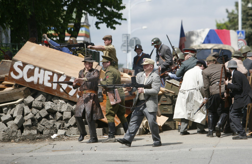 Actors in Prague dressed as resistance fighters reenact the uprising in May 1945. (photo credit: DAVID W. CERNY / REUTERS)