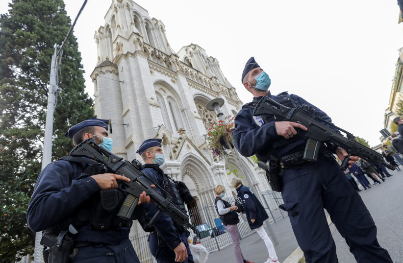 Police officers stand near Notre Dame church, where a knife attack took place, in Nice, France October 29, 2020. (photo credit: REUTERS/ERIC GAILLARD)