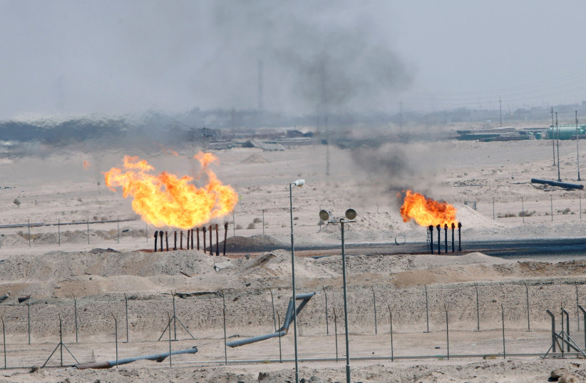 Excess gas is burnt off at a pipeline at the Zubair oilfield in Basra, Iraq August 9, 2017 (photo credit: ESSAM AL-SUDANI/ REUTERS)