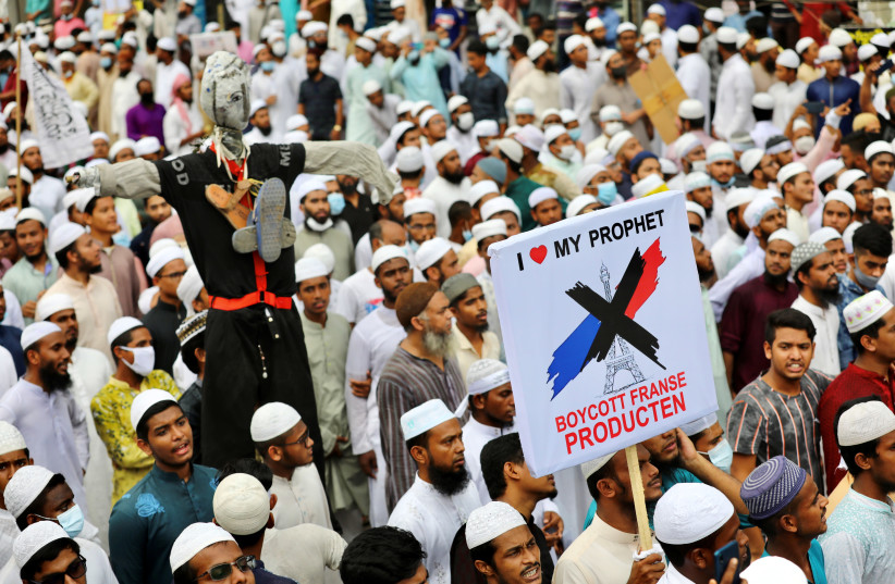 Supporters and activists of the Hefazat-e-Islam Bangladesh, an Islamist political party, hold placards as they take part in a protest calling for the boycott of French products, in Dhaka, Bangladesh, November 2, 2020 (photo credit: REUTERS/MOHAMMAD PONIR HOSSAIN)