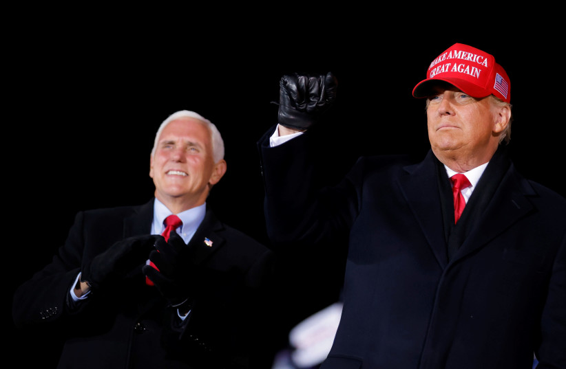 U.S. President Donald Trump gestures next to Vice President Mike Pence, as he holds a campaign rally at Gerald R. Ford International Airport in Grand Rapids, Michigan, U.S., November 2, 2020 (credit: CARLOS BARRIA / REUTERS)