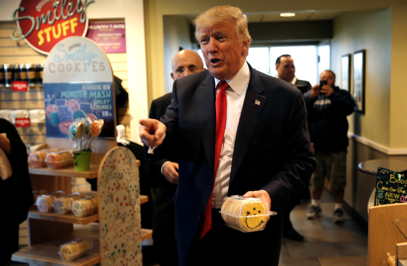 Then Republican US presidential nominee Donald Trump and former New York City Mayor Rudolph Giuliani (rear L) make a stop to buy cookies at the Eat'n Park restaurant in Moon Township, Pennsylvania, October 10, 2016. (photo credit: REUTERS)