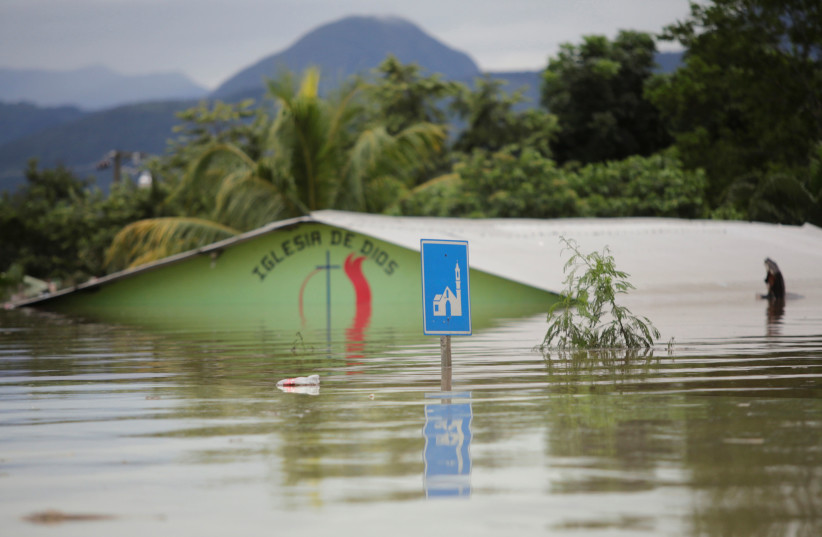 A submerged evangelical church is seen along a flooded street during the passage of Storm Eta, in Pimienta, Honduras November 5, 2020. REUTERS/Jorge Cabrera (photo credit: JORGE CABRERA/ REUTERS)