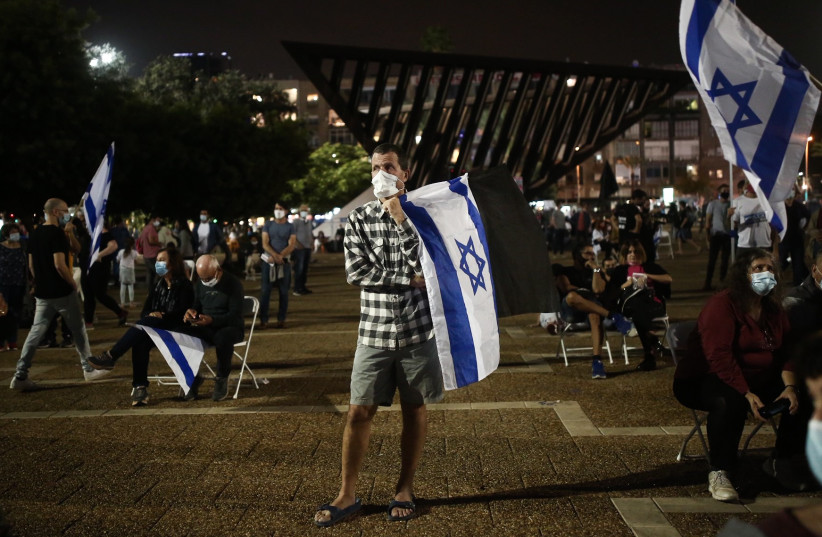 Israelis gather at Rabin Square in Tel Aviv for a remembrance ceremony marking 25 years since the assassination of late Israeli Prime Minister Yitzhak Rabin, held on November 7, 2020. (photo credit: MIRIAM ALSTER/FLASH90)