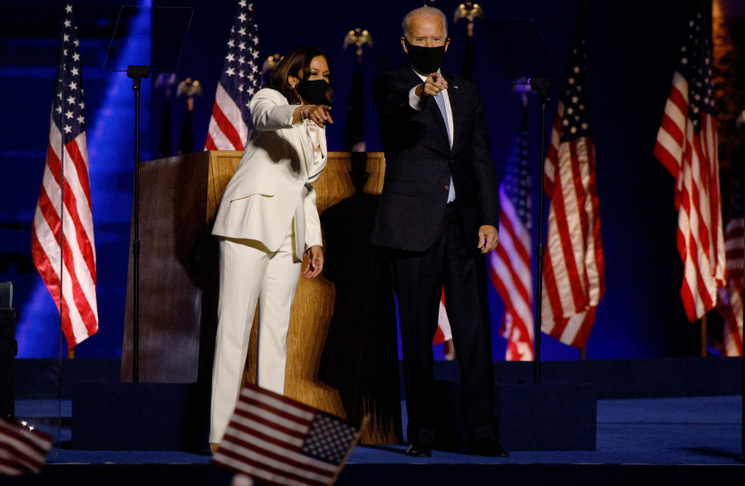 Democratic 2020 U.S. presidential nominee Joe Biden joins vice presidential nominee Kamala Harris onstage at their election rally, after the news media announced that Biden has won the 2020 U.S. presidential election over President Donald Trump, in Wilmington, Delaware, U.S., November 7, 2020. (photo credit: JIM BOURG / REUTERS)