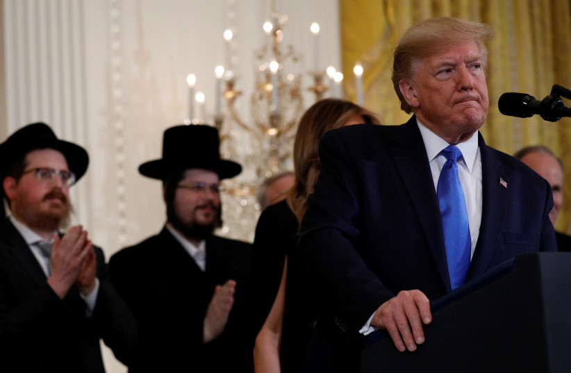 US President Donald Trump speaks during a Hanukkah reception and executive order against antisemitism signing in the East Room of the White House in Washington, US, December 11, 2019 (photo credit: REUTERS/TOM BRENNER)