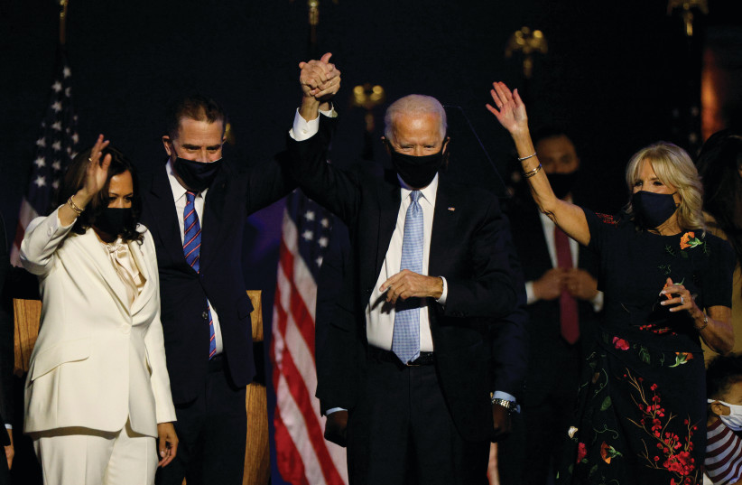 US PRESIDENT-ELECT Joe Biden celebrates in Wilmington, Delaware, on Saturday, with his wife, Jill, his son Hunter Biden and Vice President-elect Kamala Harris. (photo credit: JIM BOURG / REUTERS)