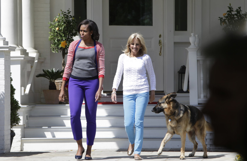 U.S. First Lady Michelle Obama (L) and Jill Biden, wife of Vice President Joe Biden, walk out with Biden's family dog Champ to host a Joining Forces Service event at the Naval Observatory in Washington May 10, 2012. (photo credit: YURI GRIPAS/REUTERS)