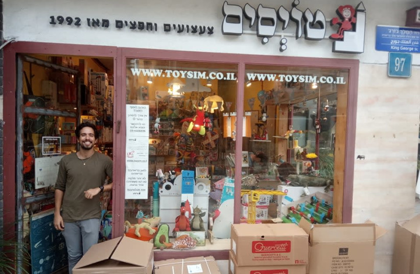 Toysim owner Tzuf Solomon at the front of his store. The interview was done while he was wearing a mask (photo credit: HAGAY HACOHEN)