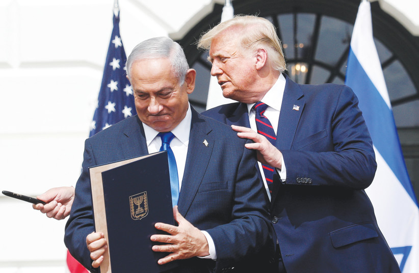 Prime Minister Benjamin Netanyahu stands with US President Donald Trump after signing the Abraham Accords, at the White House earlier this year. (photo credit: TOM BRENNER/REUTERS)