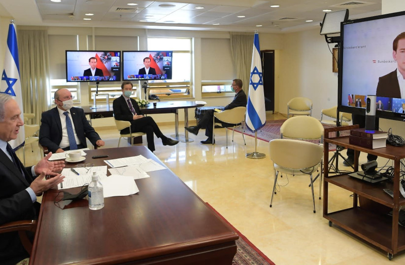 Netanyahu attends an international video conference with world leaders about latest developments on coronavirus, Nov. 10, 2020. (photo credit: AMOS BEN GERSHOM, GPO)