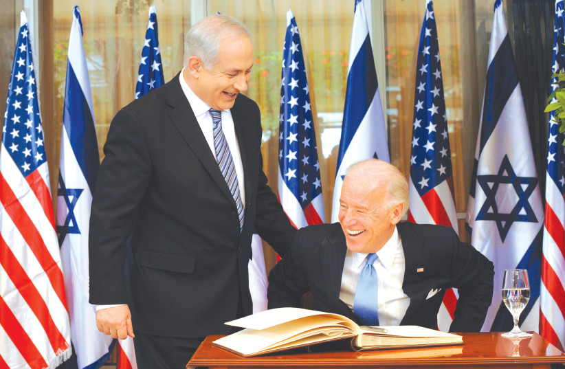 Prime Minister Benjamin Netanyahu laughs with then-vice president Joe Biden after he signed the guest book at the Prime Minister’s Residence in Jerusalem on March 9, 2010 (photo credit: DEBBIE HILL/REUTERS)