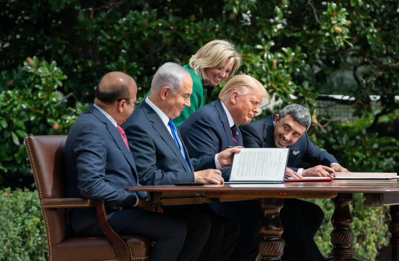 US President Donald Trump (2nd R), Israeli Prime Minister Benjamin Netanyahu (2nd L), UAE Foreign Minister Abdullah bin Zayed Al Nahyan (R) and Bahrain Foreign Minister Abdullatif bin Rashid Al Zayani (L) attend a signing ceremony for the agreements on "normalization of relations" reached between Is (photo credit: (THE WHITE HOUSE/ANDREA HANKS/ANADOLU AGENCY VIA GETTY IMAGES))