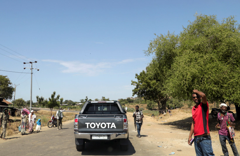 Members of Amhara militia control a motor vehicle checkpoint at the entrance of Dansha town in Tigray Region (photo credit: REUTERS)