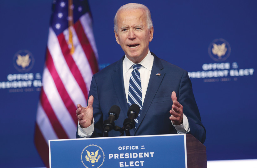 US PRESIDENT-ELECT Joe Biden speaks about healthcare at the theater serving as his transition headquarters in Wilmington, Delaware, on Tuesday. (photo credit: JONATHAN ERNST / REUTERS)