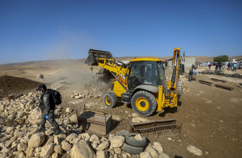 Israeli authorities demolish a house and a shed near the West Bank city of Hebron, on October 18, 2020. (photo credit: WISSAM HASHLAMON/FLASH90)