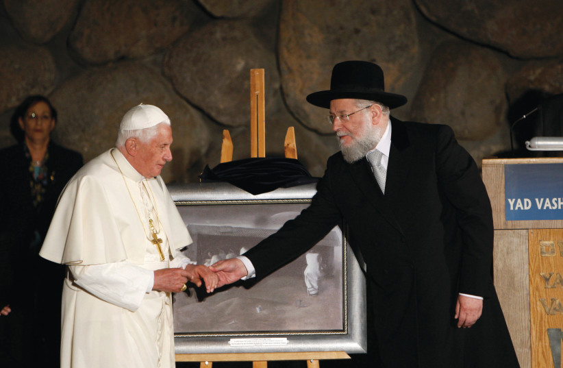 RABBI ISRAEL MEIR LAU, one of the interviewees in ISResilience, (right) touches the hand of Pope Benedict XVI at Yad Vashem in 2009.  (photo credit: RONEN ZVULUN/REUTERS)