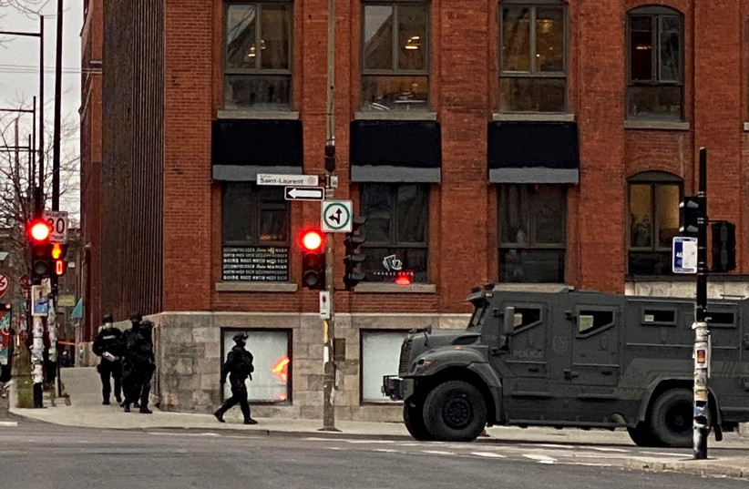 Police maintain a security cordon after media reports of a hostage incident at the offices of gaming software developer Ubisoft in Montreal, Quebec, Canada November 13, 2020. (photo credit: CHRISTINNE MUSCHI/REUTERS)