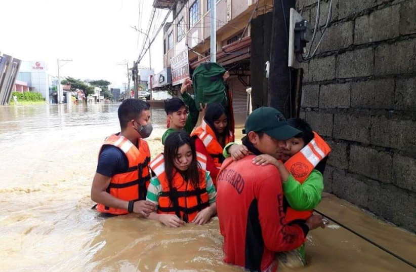 Philippine Coast Guard conduct a rescue operation, after Typhoon Vamco resulted in severe flooding, in the Cagayan Valley region in northeastern Philippines, November 13, 2020. Picture taken November 13, 2020.  (photo credit: PHILIPPINE COAST GUARD/HANDOUT VIA REUTERS)