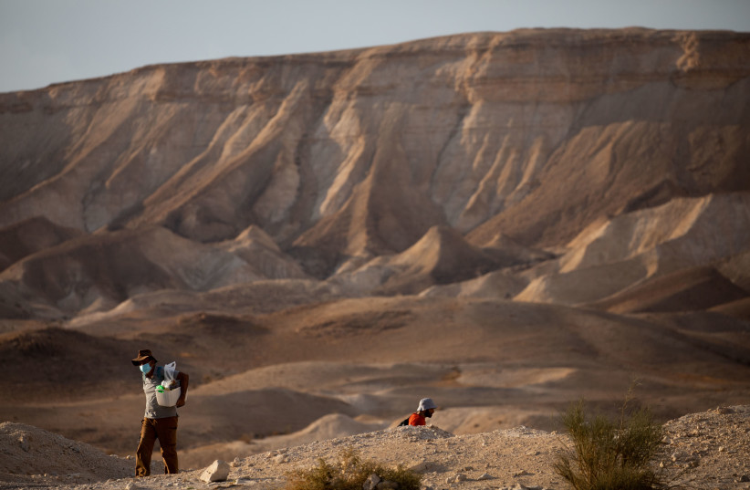 People hike in the Judean desert, in the West Bank, on November 5, 2020. (photo credit: YONATAN SINDEL/FLASH90)