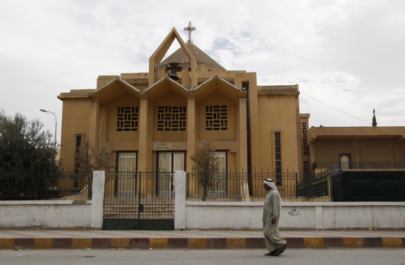 A man walks past the The Martyrs Church in the city centre of Raqqa, September 19, 2013 (photo credit: REUTERS/STRINGER)