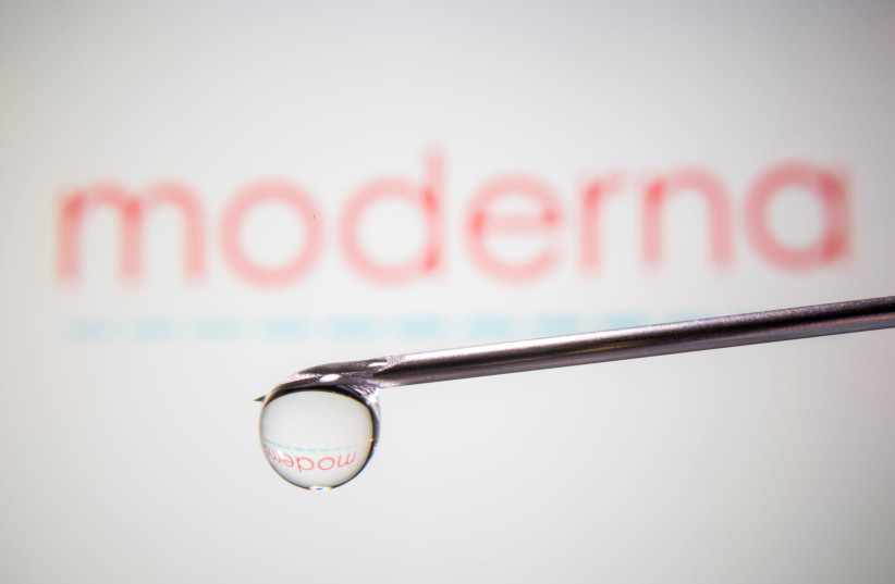 Moderna's logo is reflected in a drop on a syringe needle in this illustration taken November 9, 2020 (photo credit: REUTERS/ DADO RUVIC)