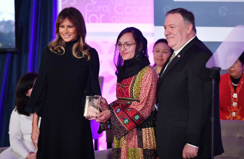 First Lady Melania Trump and US Secretary of State Mike Pompeo present a 2020 International Women of Courage Award to Zarifa Ghafari, March 4, 2020 (photo credit: ERIN SCOTT/SIPA USA)