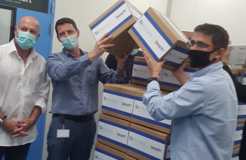 From right to left: Seach Medical Group CEO Yogev Sarid, Panaxia CEO Dadi Segal and Head of Israel's Medical Cannabis Unit Yuval Landschaf stand alongside the first commercial shipment of medical cannabis from Israel. (photo credit: Courtesy)