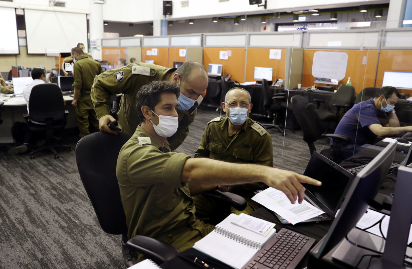 Israeli soldiers at the IDF Corona Task Force Headquarters as they conduct epidemiological investigations as part of the army's effort to trace chains of infection to curb the spread of coronavirus, Ramle, Israel, September 17, 2020 (photo credit: RONEN ZVULUN/REUTERS)