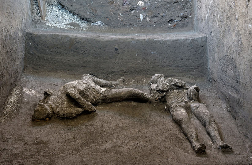 Remains of two men who died in the volcanic eruption that destroyed the ancient Roman city of Pompeii in 79 AD are discovered in a dig carried out during the coronavirus disease (COVID-19) pandemic in Pompeii, Italy November 18, 2020. Picture taken November 18, 2020. Luigi Spina/Handout via REUTERS (credit: REUTERS)