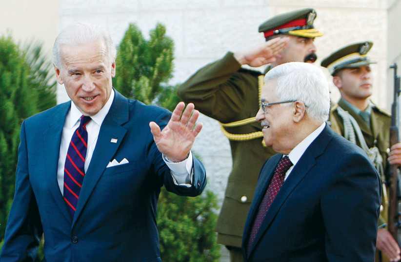 THEN-VICE PRESIDENT Joe Biden gestures as he walks with Palestinian Authority President Mahmoud Abbas after their meeting in Ramallah in 2010. (photo credit: REUTERS)