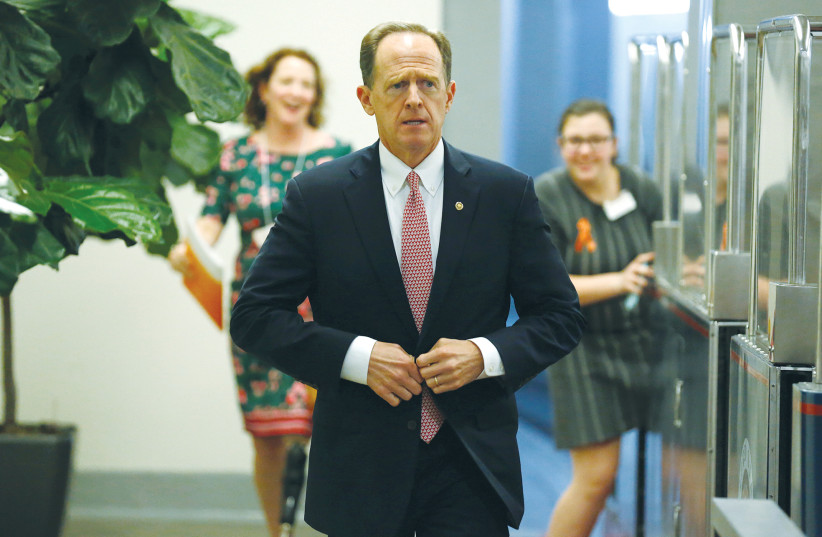 SEN. PAT TOOMEY (R-Pennsylvania) arrives for the weekly Senate Republican policy luncheon on Capitol Hill in Washington, in 2018.  (photo credit: REUTERS)