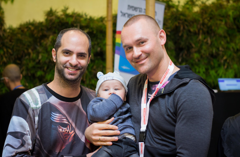 Parents who completed the surrogacy process pose at the Men Having Babies conference in Tel Aviv in 2019. (photo credit: MEN HAVING BABIES)