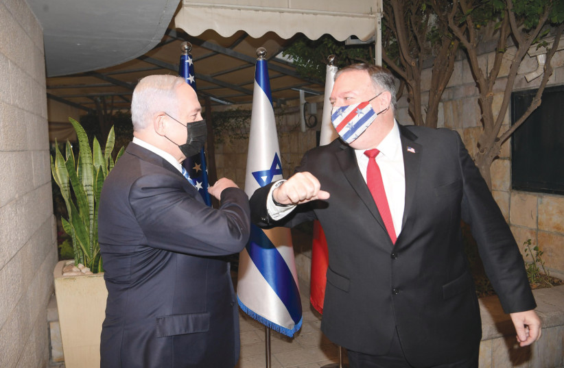 RIME MINISTER Benjamin Netanyahu greets US Secretary of State Mike Pompeo wearing a Stars and Stripes mask (photo credit: AMOS BEN GERSHOM, GPO)