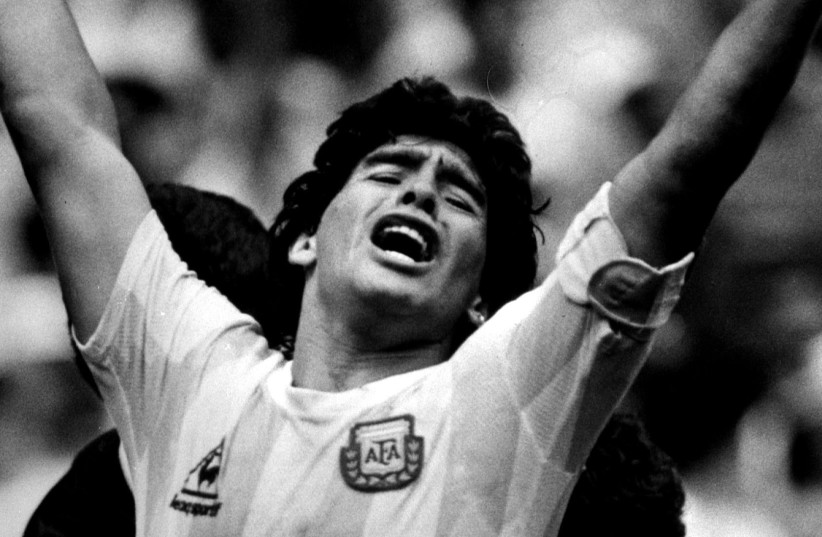 Argentine star Diego Maradona raises his arms in the air (photo credit: REUTERS)