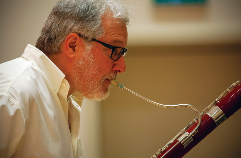Richard Paley plays on a modern bassoon (photo credit: SHAI SKIFF)