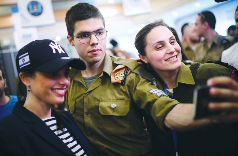 Lone soldiers snap a selfie with MK Ayelet Shaked (credit: TOMER NEUBERG/FLASH90)