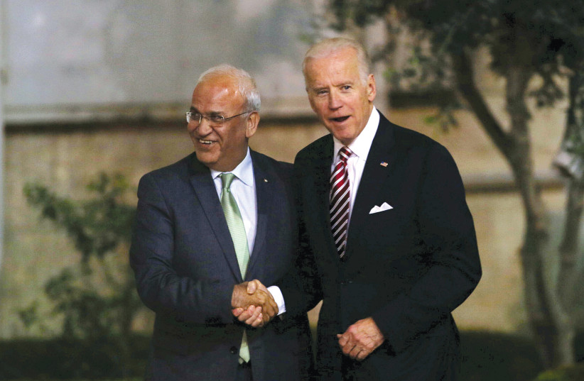 THEN-US vice president Joe Biden shakes hands with Palestinian chief negotiator Saeb Erekat upon Biden’s arrival in Ramallah in 2016.  (photo credit: REUTERS)