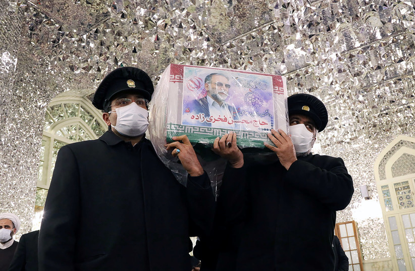Servants of the holy shrine of Imam Reza carry the coffin of Iranian nuclear scientist Mohsen Fakhrizadeh, in Mashhad, Iran November 29, 2020. (photo credit: MASSOUD NOZARI/WANA VIA REUTERS)