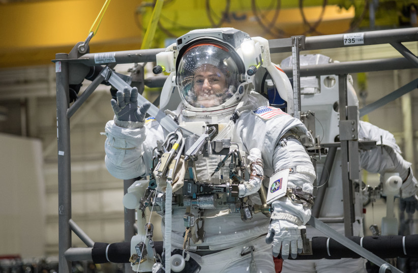 Jessica Meir prepares to be submerged in NASA's 6.2 million gallon Neutral Buoyancy Laboratory for spacewalk training. (photo credit: NASA/JOSH VALCARCEL)