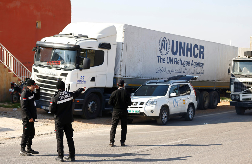 Syria-bound trucks, loaded with humanitarian supplies, get ready to leave a UN transhipment hub in Reyhanli, near the Turkish-Syrian border in Hatay province (photo credit: REUTERS)