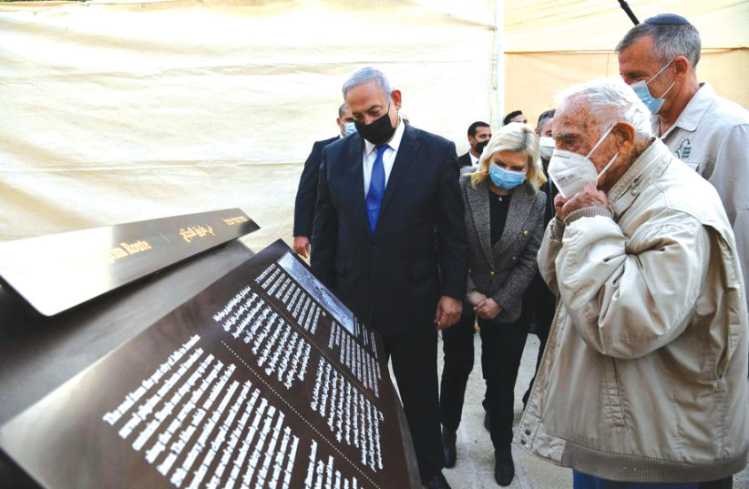 PRIME MINISTER Benjamin Netanyahu, his wife, Sara, and Palmah veteran Amos Horev (right foreground) look at the plaque in the new Legacy Museum at the old Turkish khan at Sha’ar Hagai. (photo credit: HAIM ZACH/GPO)