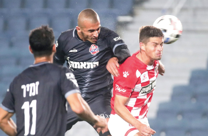 HAPOEL HAIFA (in black) and Hapoel Beersheba played to an exciting 2-2 draw on Monday night in Premier League action at Teddy Stadium. (photo credit: DANNY MARON)