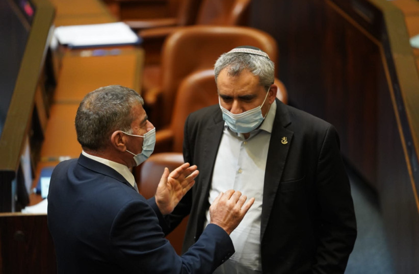 Foreign Minister Gabi Ashkenazi (L) is seen talking with Higher Education Minister Ze'ev Elkin during the preliminary voting plenum to dissolve the Knesset on December 2, 2020. (photo credit: KNESSET SPOKESPERSON/DANI SHEM TOV)